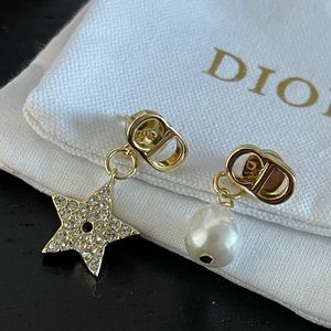 Womens Dior pearl and star charm earrings